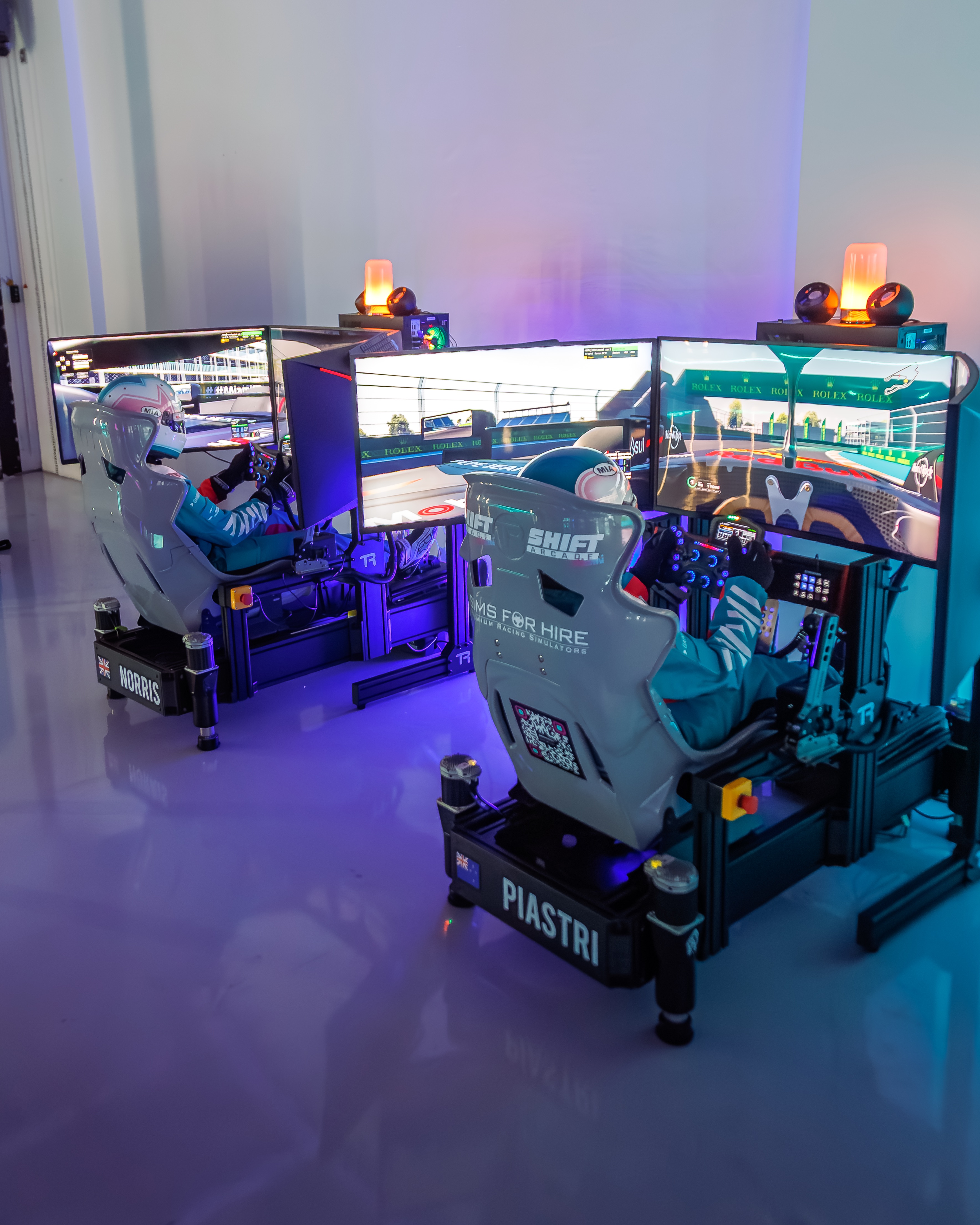 Guests racing on full-motion simulators at Hard Rock event