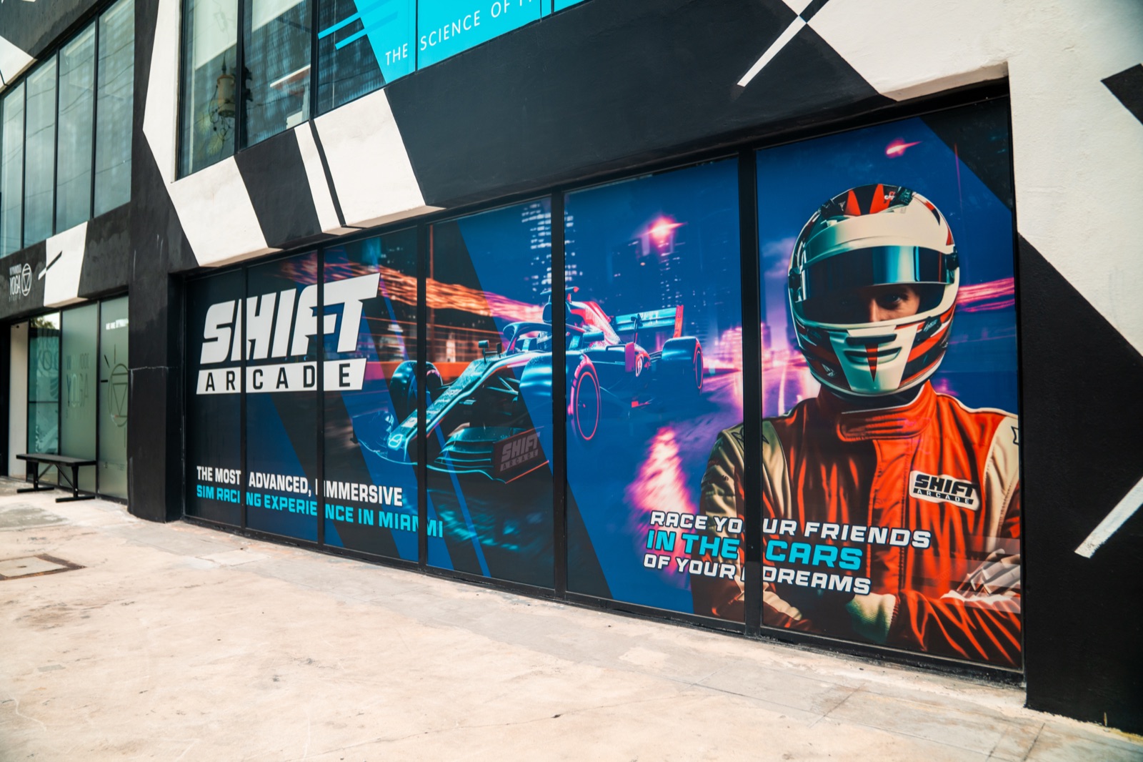 Full-motion racing simulator rig with triple screens in Homestead