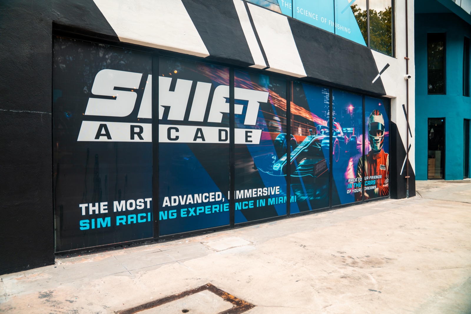 Full-motion racing simulator rig with triple screens in Doral