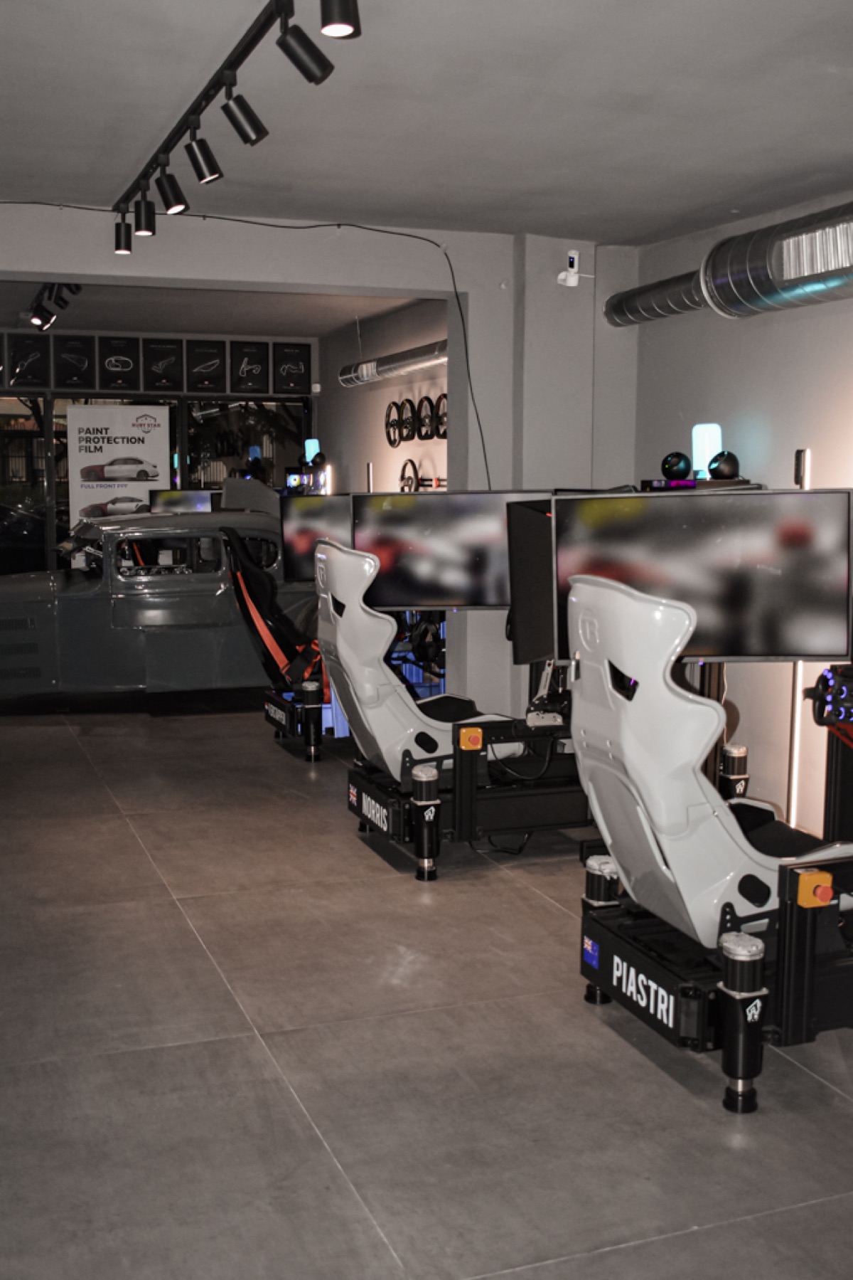 Full-motion racing simulator rig with triple screens in Miami