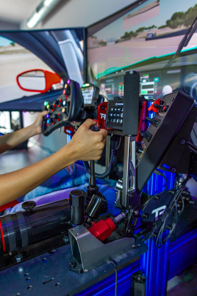 Full-motion racing simulator rig with triple screens in Riviera Beach