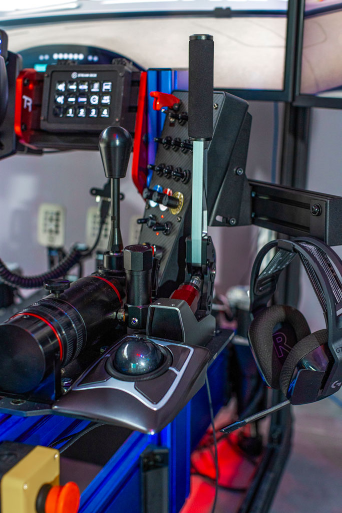 Full-motion racing simulator rig with triple screens in Tequesta